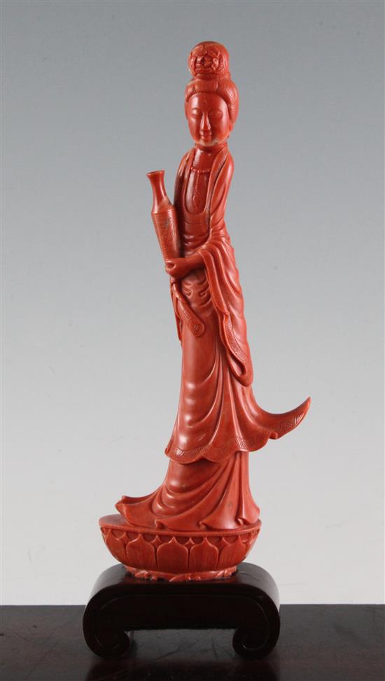 A large Chinese coral figure of Guanyin, 27.7cm incl. wood stand